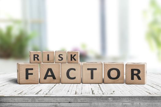 Risk factor sign on a wooden table in a bright living room in fresh daylight