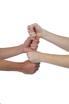 People stacking their fistsÂ against white background