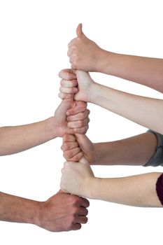 People stacking their fistsÂ against white background