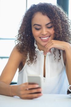 Beautiful woman using mobile phone in a restaurant