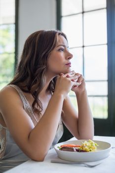 Depressed woman sitting in the restaurant