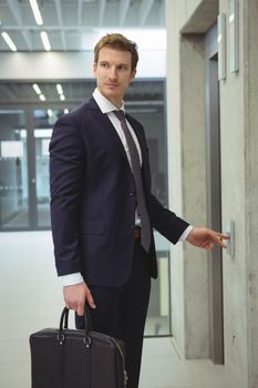 Businessman waiting for an elevator in office