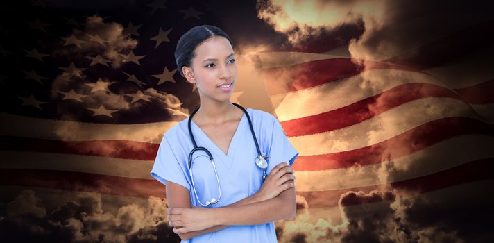 Smiling  doctor with stethoscope against composite image of digitally generated american flag rippling