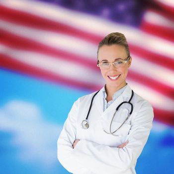 Beautiful female doctor with arms crossed in hospital against composite image of close-up of american flag
