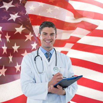 Portrait smiling doctor writing on clipboard against focus on usa flag