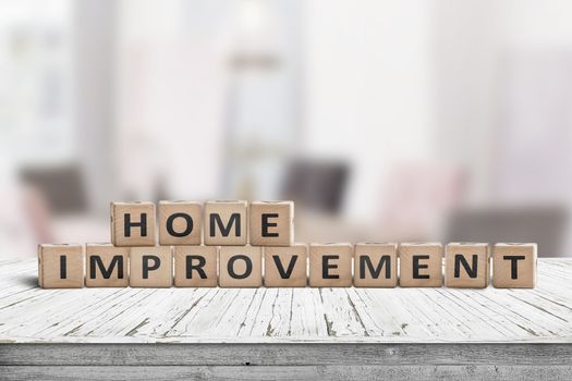 Home improvement sign in a bright room on a wooden desk in white paint