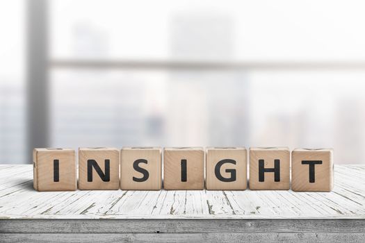 Sign with the word insight in a bright office environment on a white table