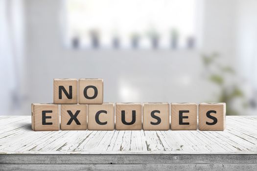 No excuses sign in a bright room on a wooden table with worn planks
