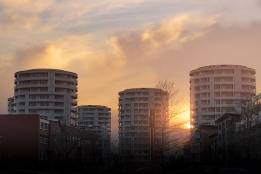 Round tower appartments in the sunset rising up in the city