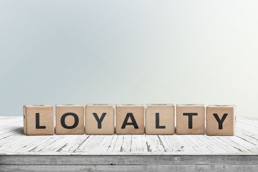 Loyalty sign on a wooden table in bright daylight in a room