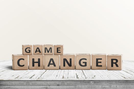 Game changer sign made of wooden blocks on a desk in a bright room