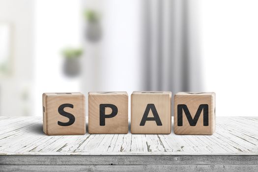 Spam sign on a white desk with wooden blocks in a bright room