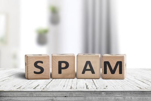 Spam sign on a white desk with wooden blocks in a bright room