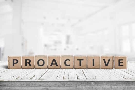 Proactive sign on a wooden table in a bright office in daylight