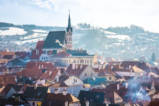 the sunrise view of cesky krumlov saint vitus church and the small town surrounding it.