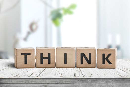 Think message sign on a worn table in a bright room in daylight