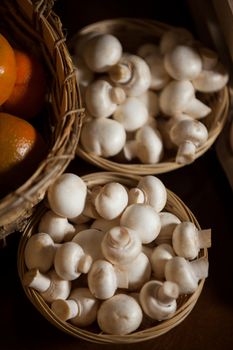 Close-up of fresh mushrooms in wicker basket at organic section