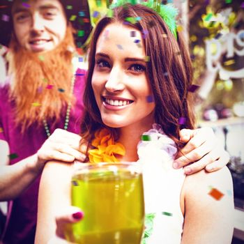 Flying colours against portrait of smiling woman holding green pint 3d