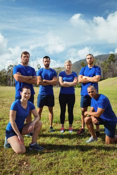 Fit people posing together in the boot camp