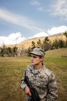 Military soldier guarding with a rifle in a boot camp