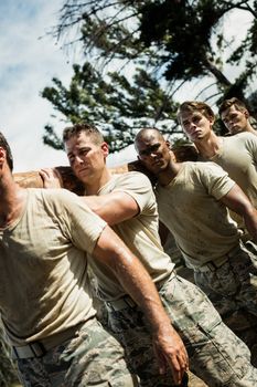 Soldiers carrying a tree log in boot camp