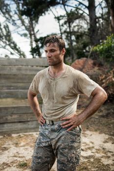 Soldier sitting on his knees with hands on his hip in boot camp