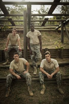 Portrait of Soldiers sitting on the obstacle course in boot camp