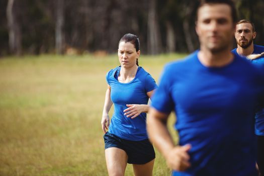 Fit people running in boot camp