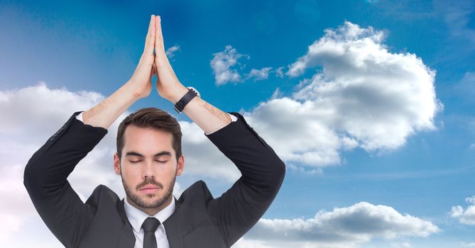 Digital composite of Businessman Meditating yoga in front of sky