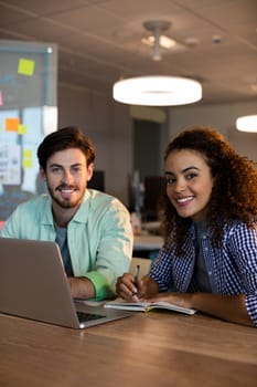 Portrait of creative business people working on desk at office