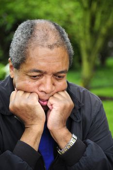 African american male relaxing alone outdoors.