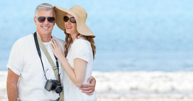 Digital composite of Couple summer clothes against blurry beach