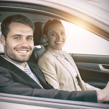 Couple in a car looking at the camera