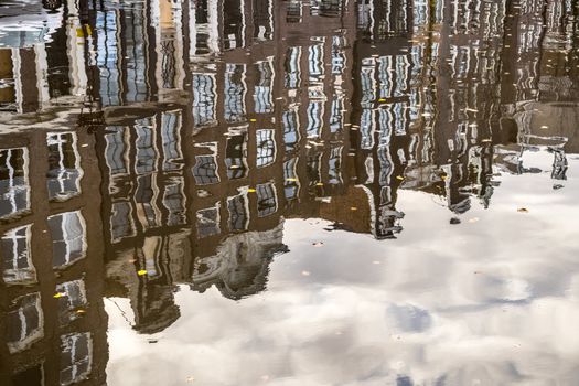 Amstedam, capital of Netherlands. Water reflections of traditional houses by the street canal.