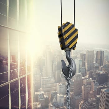 Studio Shoot of a crane lifting hook against image of a city landscape on a sunny day 