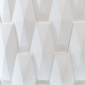 3D decorative wall for the interior of an unusual geometric shape. White light background with a pattern imitating a tree. Abstract texture