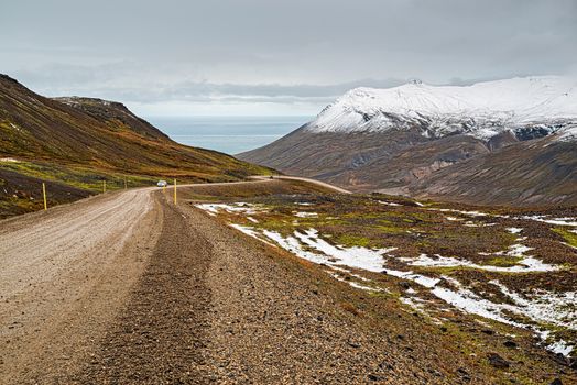 Off road in the mountains and ocean view in Borgarfjordur Eystri in east Iceland in a cloudy day