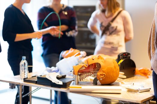 Medical doctor specialist expert displaying method of patient intubation technique on hands on medical education training and workshop.