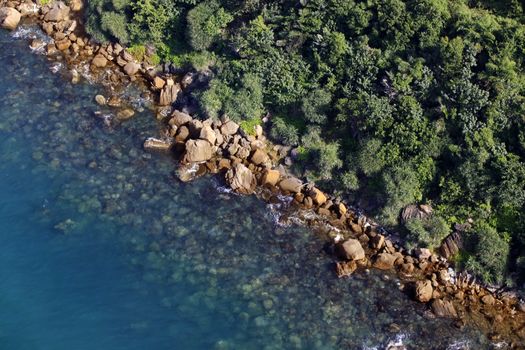 Aerial view of turquoise sea water and rocky coastline. Summer vacation concept. Vietnam, Phu Quoc