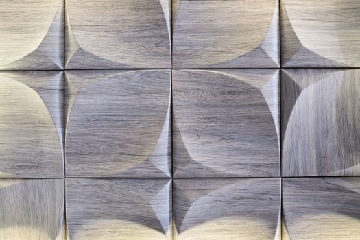 3D decorative wall with imitation wood texture for the interior of an unusual geometric shape. Gray-brown light background with a pattern imitating a tree. Abstract texture