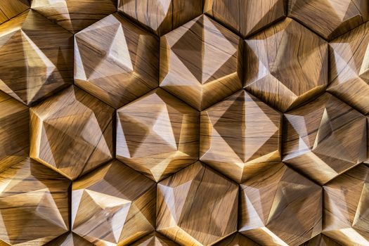 3D decorative wall with imitation wood texture for the interior of an unusual hexagonal geometric shape similar to honeycombs. Brown light background with a pattern imitating a tree. Abstract texture