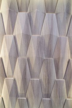 3D decorative wall with imitation wood texture for the interior of an unusual geometric shape. Gray-brown light background with a pattern imitating a tree. Abstract texture