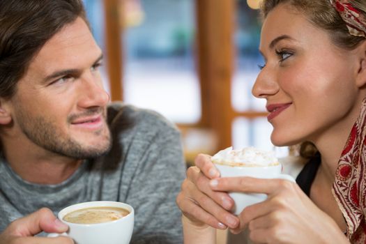 Close-up of romantic young couple having coffee in cafeteria