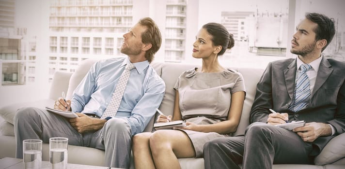 Young business people with notes in meeting at office