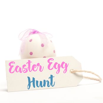 Easter greeting against blank tag in front of easter egg