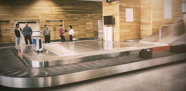 People standing by baggage claim in airport