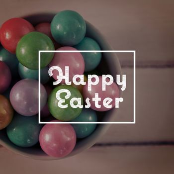 happy easter against colorful easter eggs in bowl