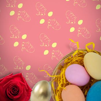 Picture of a rose against colorful easter eggs in wicker basket nest