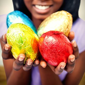 Harvester machine working on field against close up of a woman showing colorful easter eggs