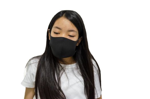 An Asian long haired girl wearing a black mask is ill with the flu. On a white background. Clipping path